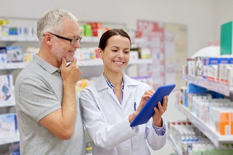 The doctor gives medicine for parasites to a man